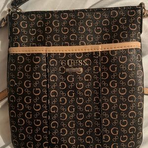 Lightly used Guess cross body purse 9”w 10” deep, long adjustable body strap